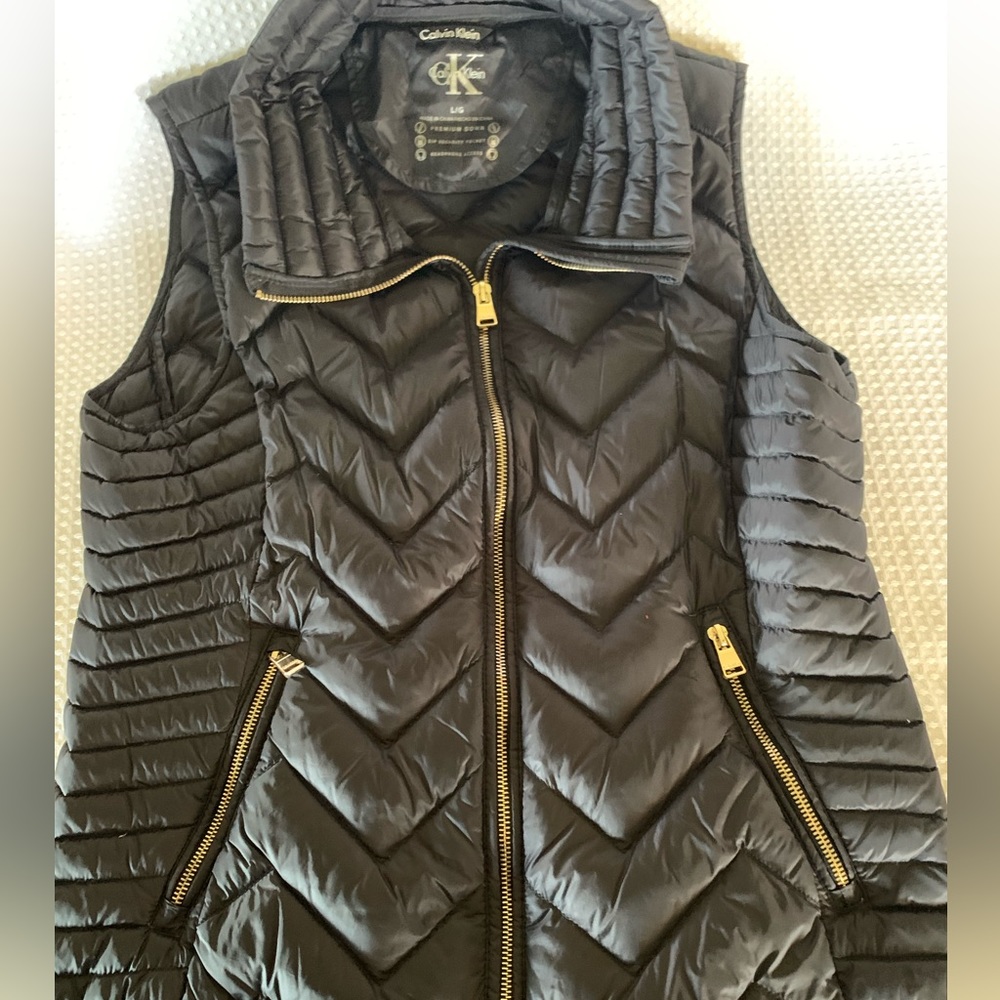 Calvin Klein NWOT lightweight premium down ladies vest. Very sharp. Gold zippers